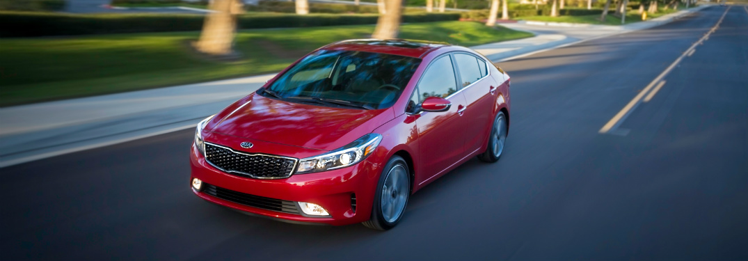 red 2018 kia forte driving on road
