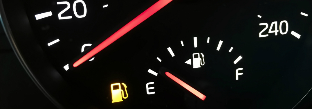 close up of fuel gauge of dashboard with low gas light on