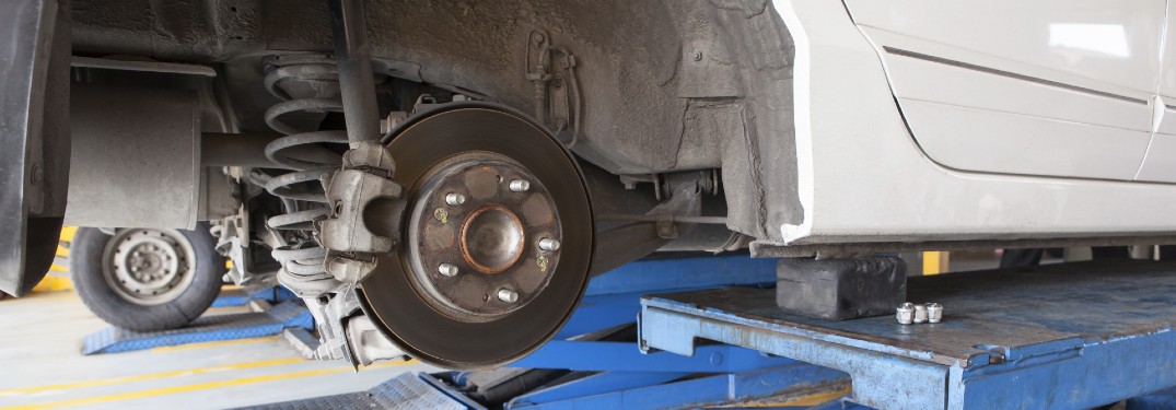 car on lift with tire off and brake rotor exposed