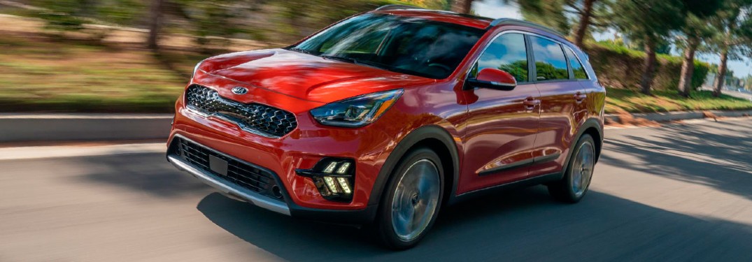 2020 Kia Niro red exterior front driver side driving on road