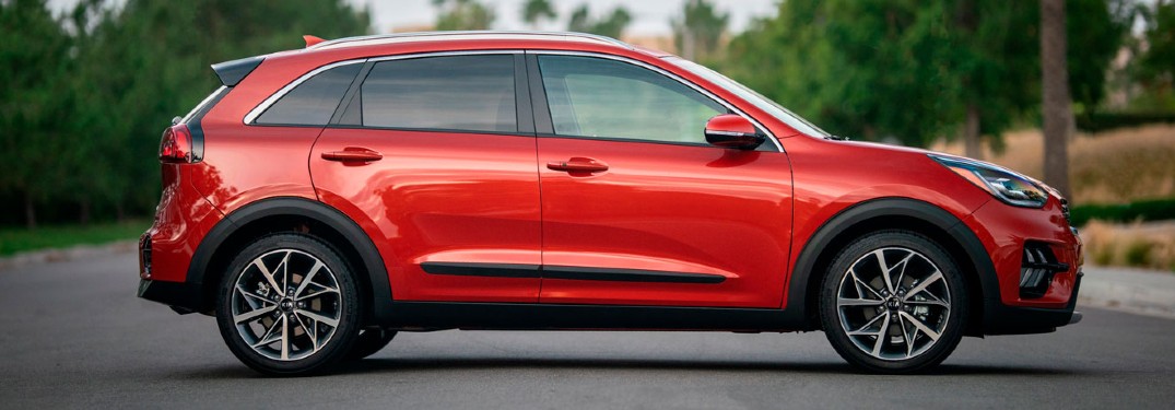 2020 Kia Niro red exterior passenger side parked in middle of road
