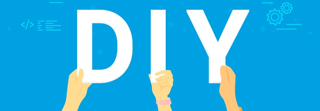 three hands holding up letters DIY