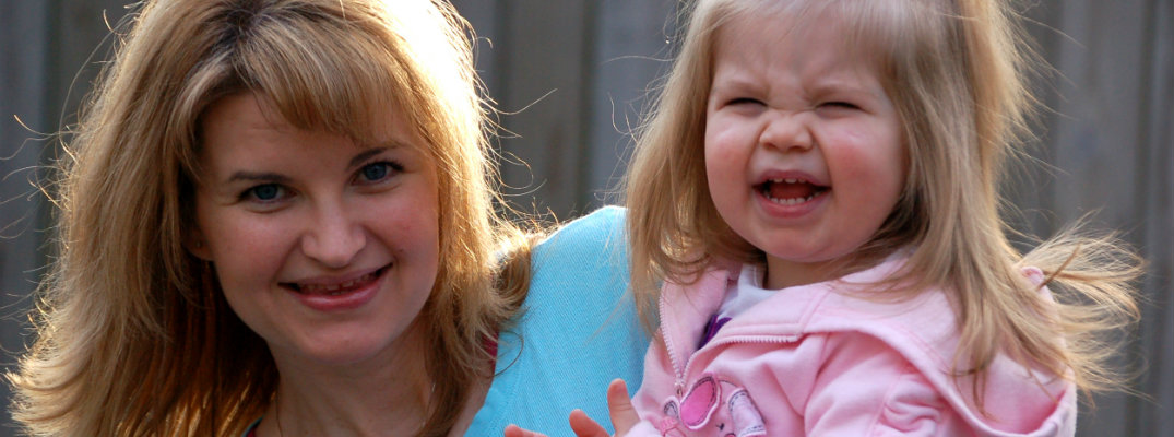 Smiling mother holding a crying child