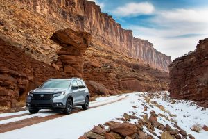 2020 Honda Passport driving between mountains