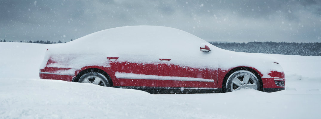 red car covered in snow