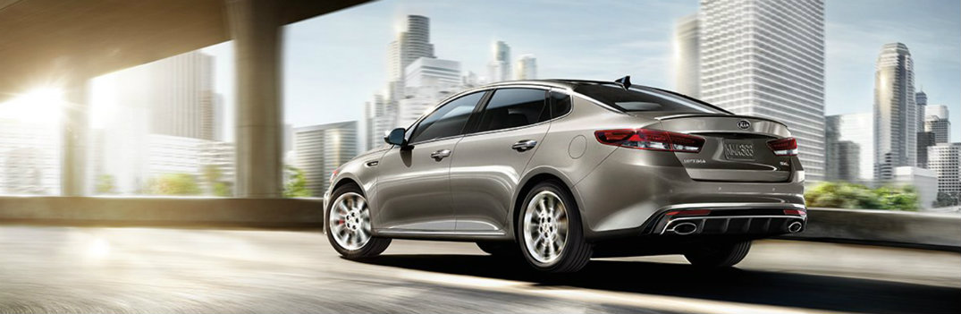 2018 Kia Optima driving under a bridge with sun glare