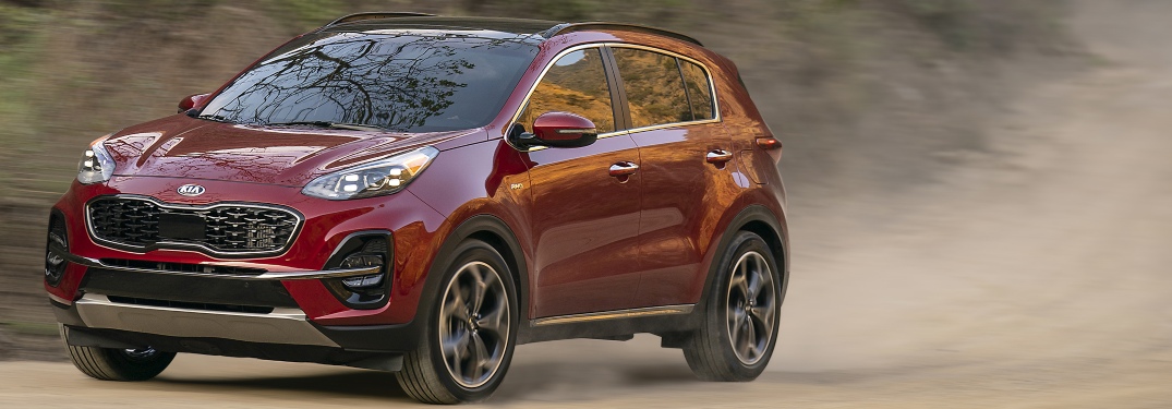 2020 Kia Sportage red side view in dirt