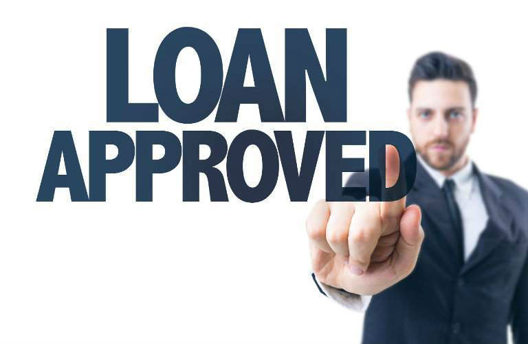 Loan approved text with man standing behind it