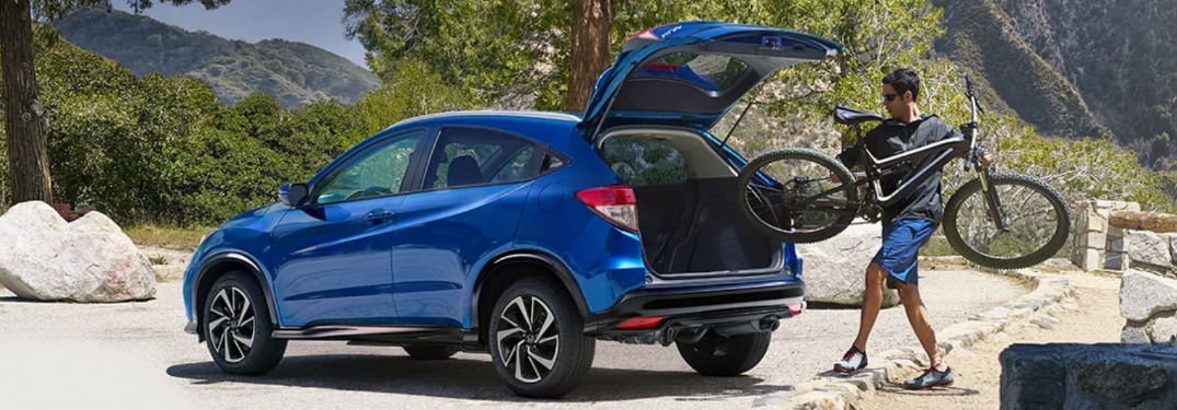 A man putting a bike into a 2021 Honda HR-V
