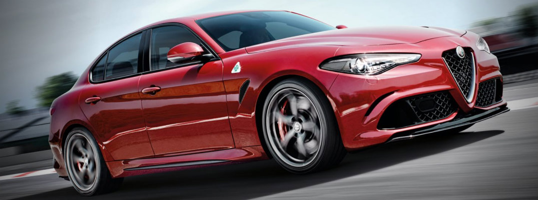 Profile view of red 2018 Alfa Romeo Giulia driving on empty road