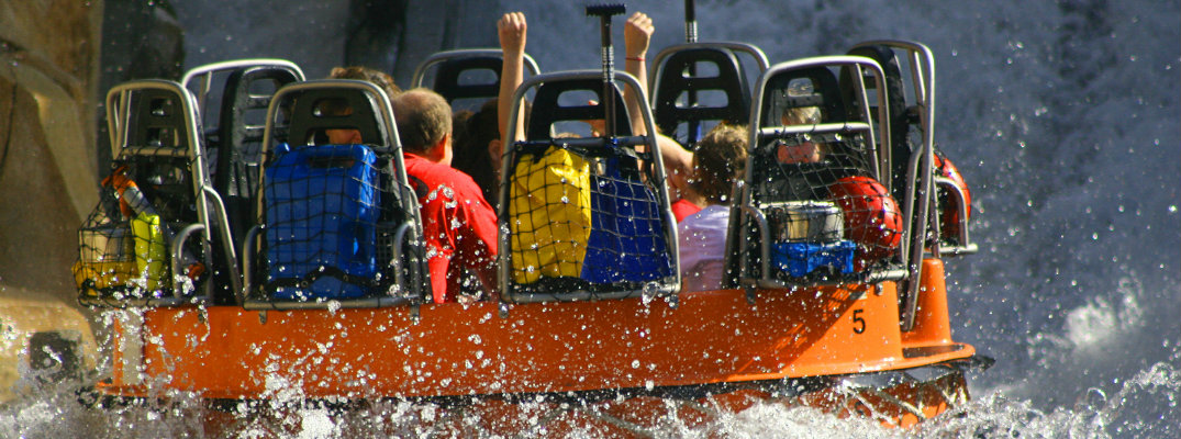 Young people having fun on waterpark ride