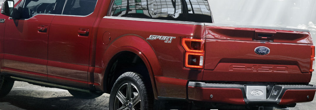 closeup of ford f-150 red color and bumper with decal