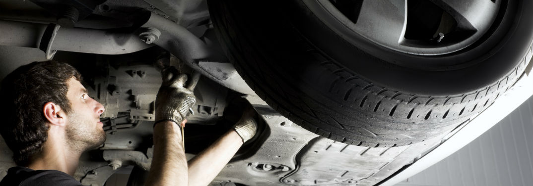 Family Kia Service Center in St. Augustine, FL with image of a mechanic doing work under a car