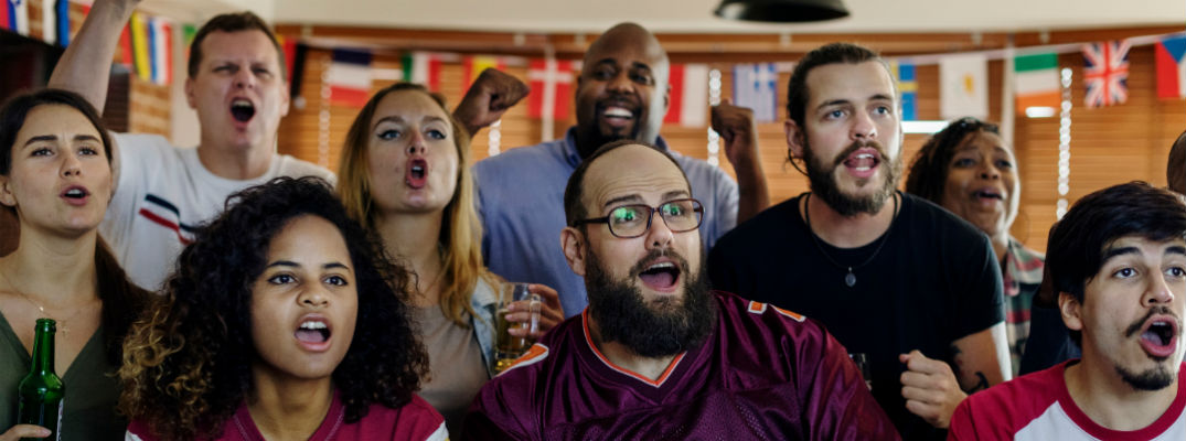 Friends at sports bar and grill watching the game