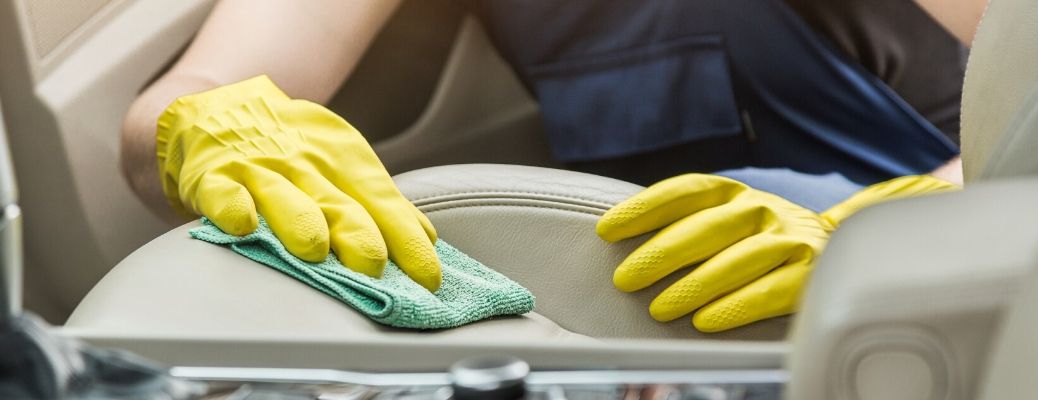 Mechanic cleaning interior of car