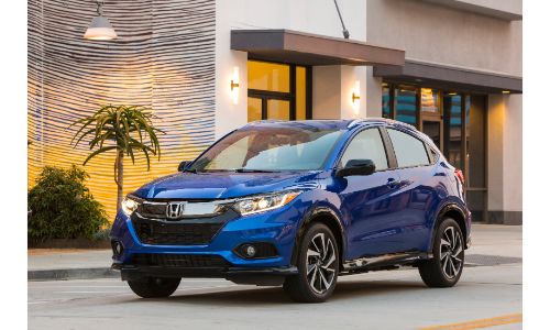 2020 Honda HR-V Sport exterior shot with Aegean Blue Metallic paint color parked outside a luxury palm cafe