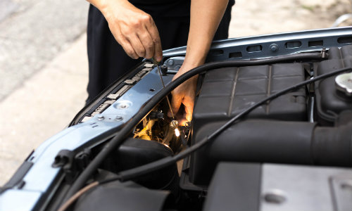a man removing and replacing a vehicle's headlight