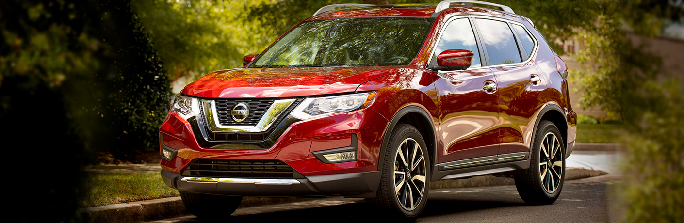 red nissan rogue front side view