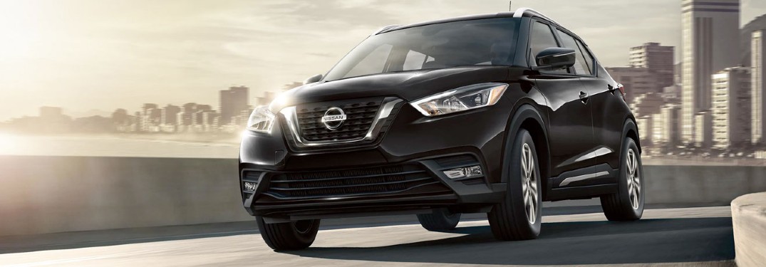 black Nissan Kicks front view on a road