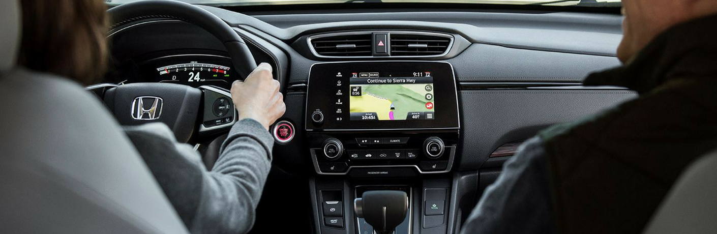 Woman and man in a car using the infotainment system on the 2018 Honda CR-V