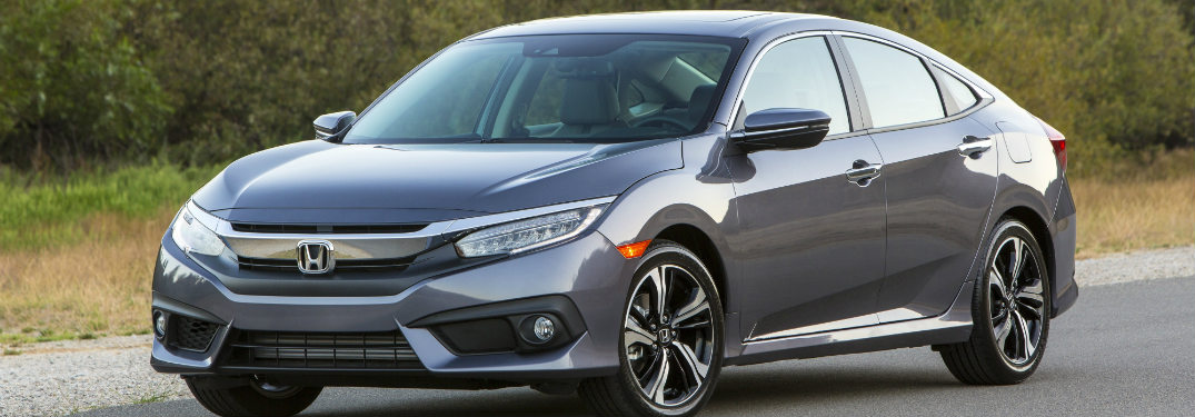 2018 Honda Civic Sedan driving fast down a road