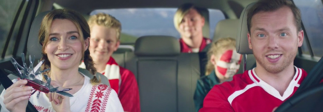 family dressed for world cup soccer mathc in volkswagen vehicle