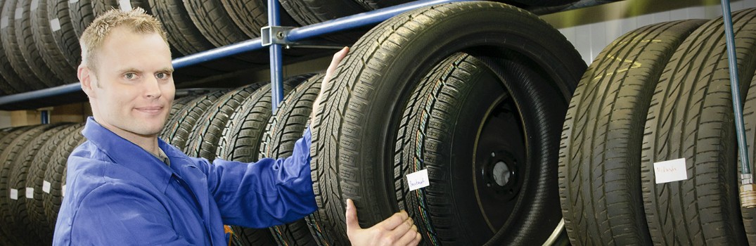 man holding a tire proudly