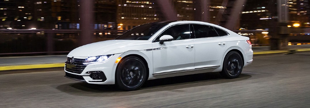 white 2020 Volkswagen Arteon driving down city street