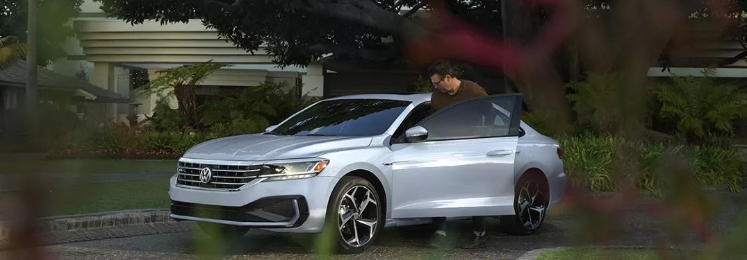 man getting into the 2021 Volkswagen Passat