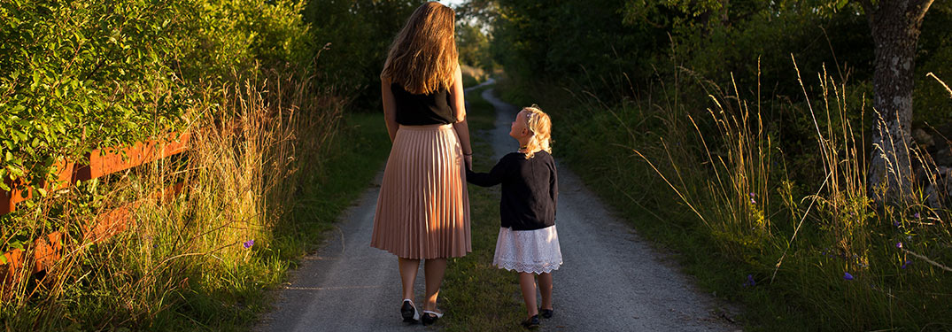 Mother and daughter holding hands