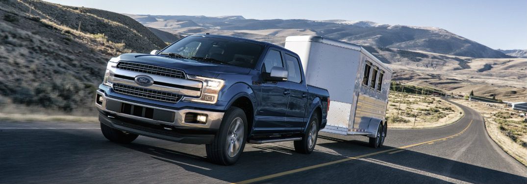 2018 Ford F-150 towing a trailer down a road