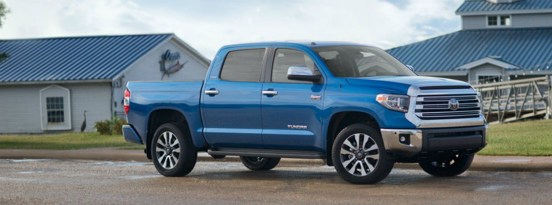 Exterior view of blue 2018 Toyota Tundra parked outside a marina
