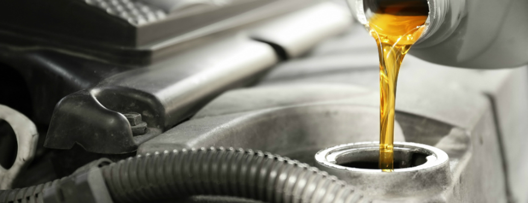 Automotive oil getting poured into a car engine