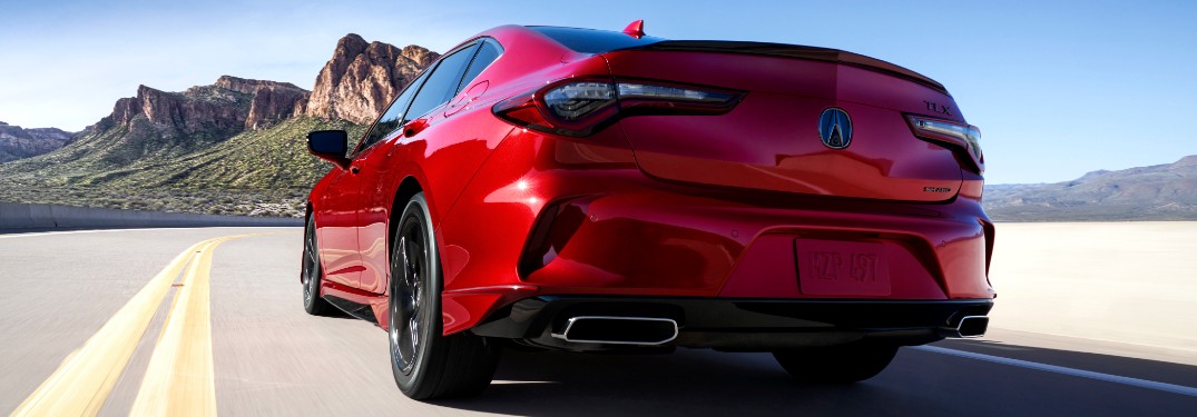 Driver's side rear angle view of red 2021 Acura TLX