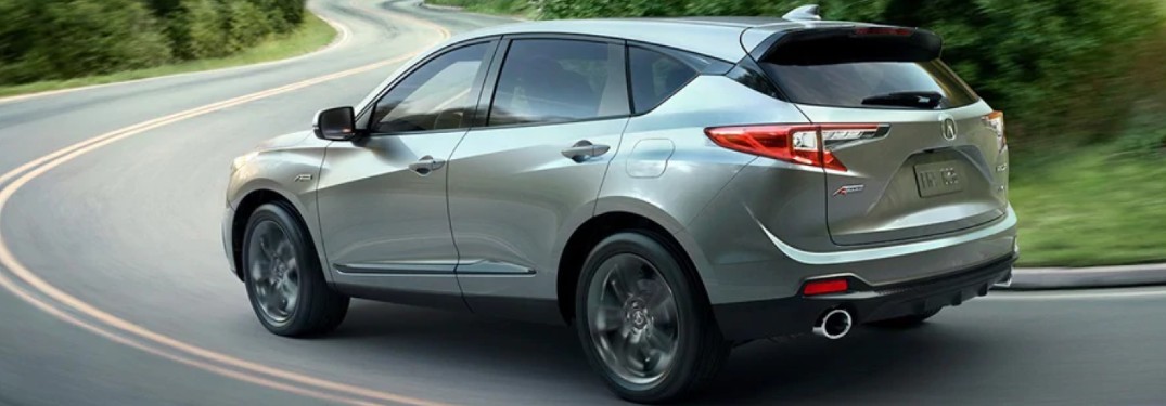 Silver 2020 Acura RDX driving on a curvy road
