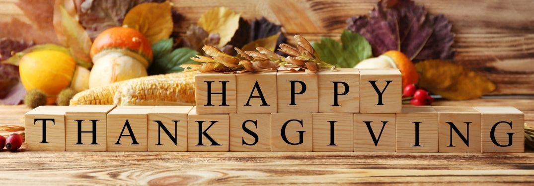 Blocks Spelling Happy Thanksgiving with Fall Decor in Background