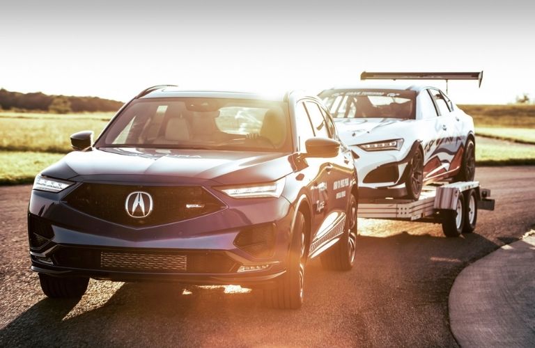 Blue 2021 Acura MDX Type S Towing an Acura Race Car at Pikes Peak