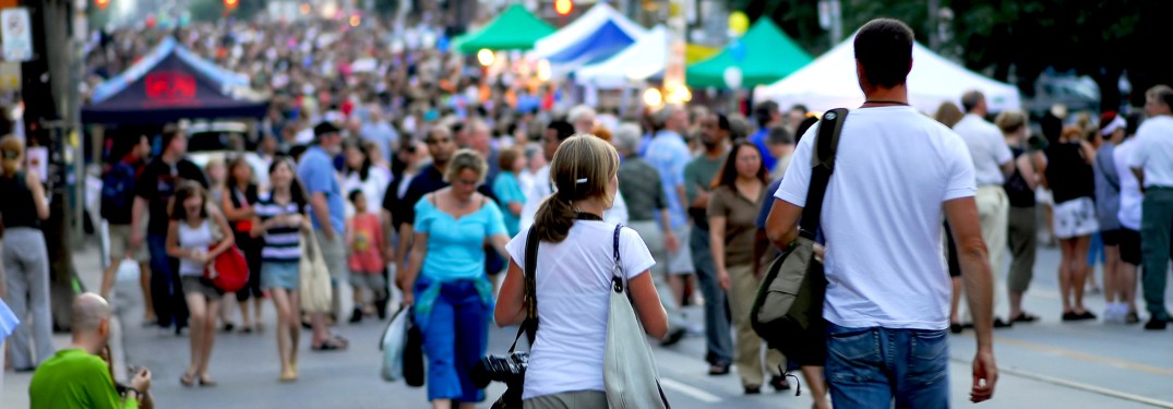 A group of people walking around a crowded festival