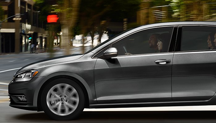 2019 Volkswagen Golf SE driving down a city street