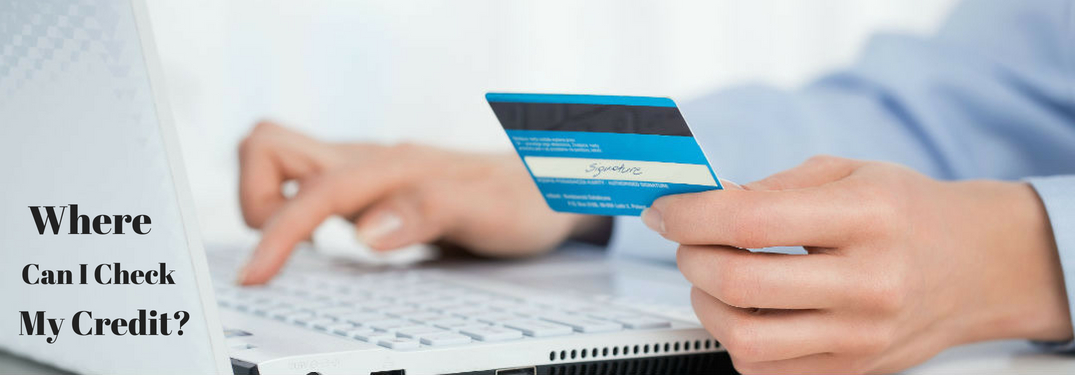 Where can I check my credit?, text on an image of a man holding a credit card in his left hand while typing on a laptop with his right hand