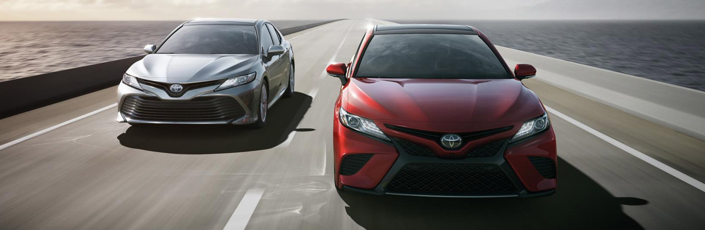 Silver and Red Toyota Camry sedans driving down the highway