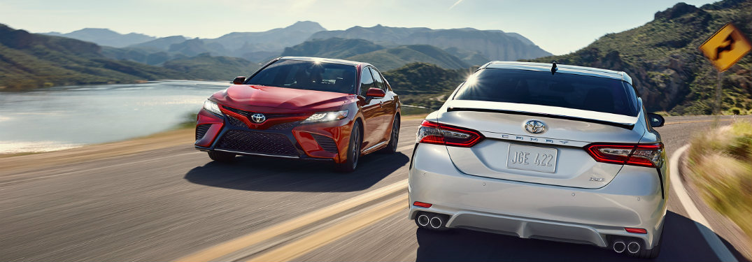 Two 2018 Toyota Camrys driving past each other