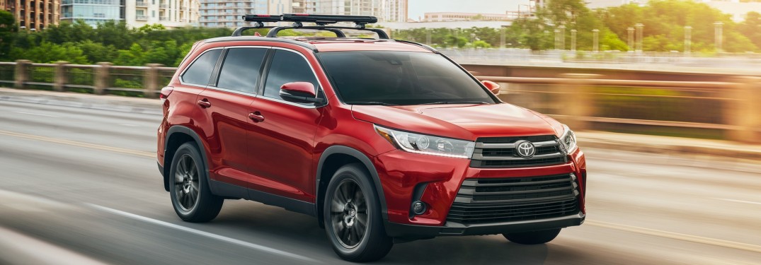 2019 Toyota Highlander driving down a city road