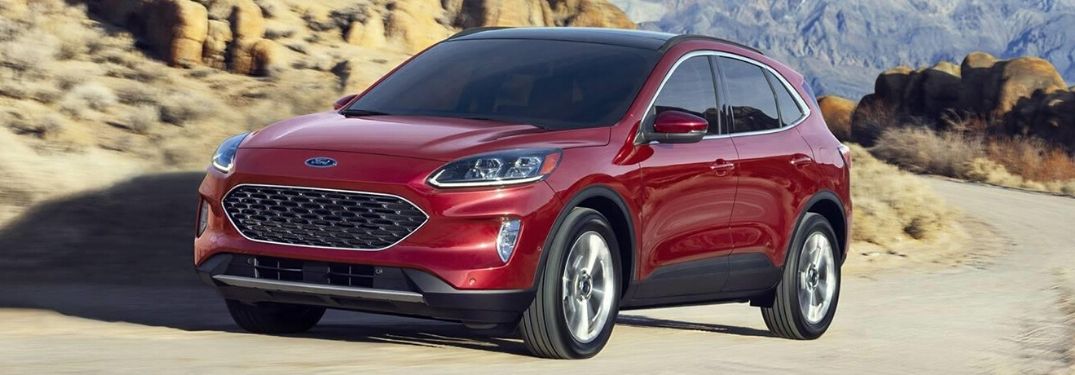 Red 2020 Ford Escape from exterior front drivers side in front of rock