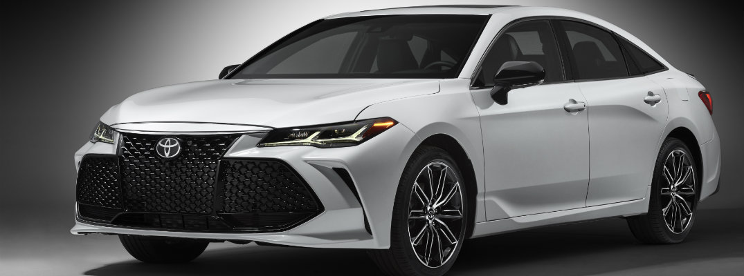 Profile shot of white and black 2019 Toyota Avalon on gray background
