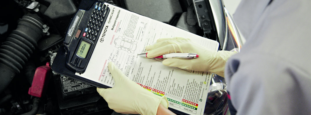 Mechanic looking at inspection spreadsheet