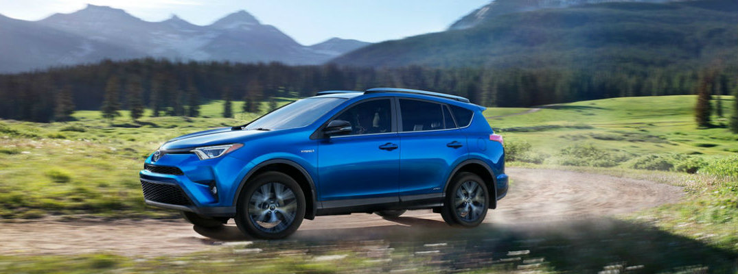 Blue 2018 Toyota RAV4 driving on mountain road