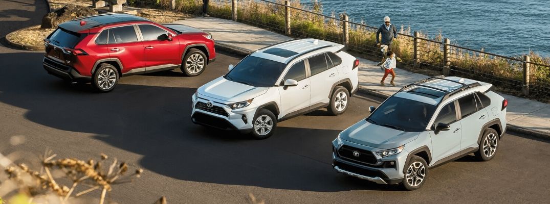 Exterior view of three 2020 Toyota RAV4 models parked in a parking lot