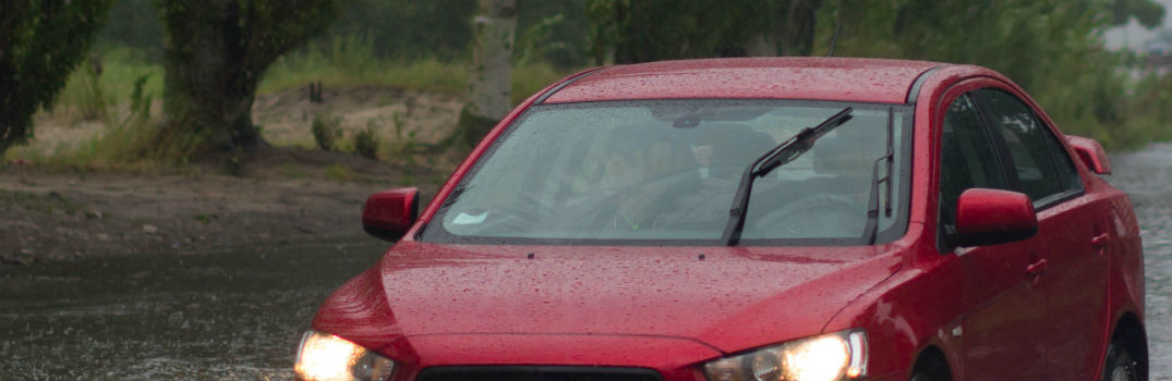 car driving through rain and flood