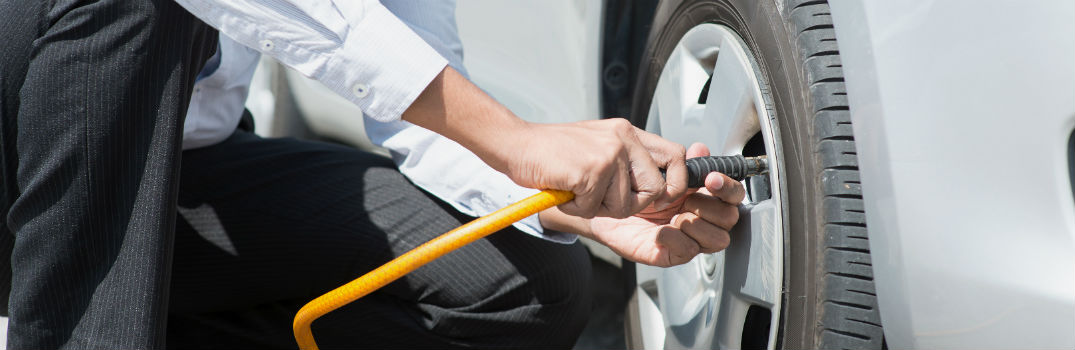 man filling up tire with air